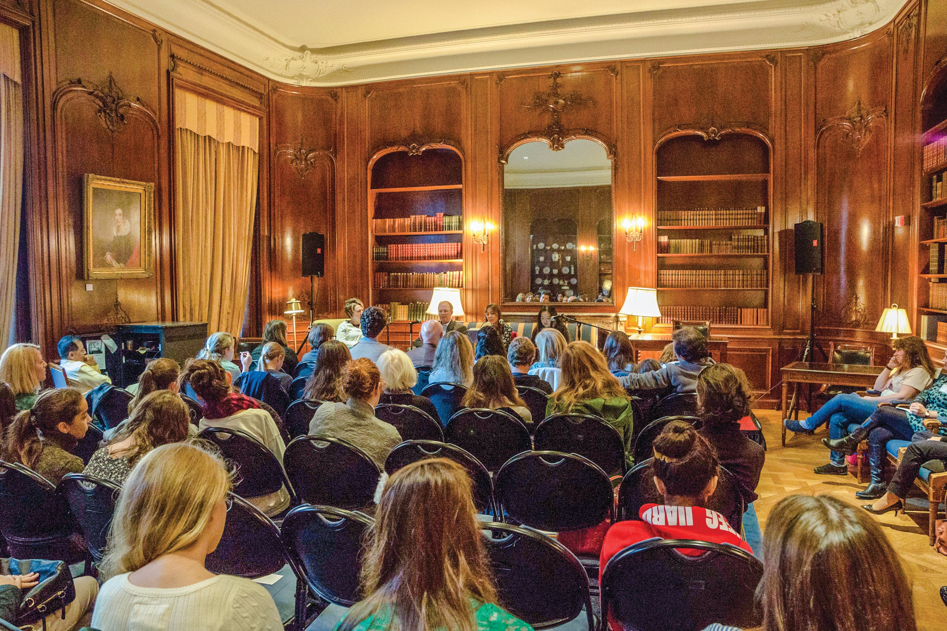NYSL members attending an event in a large library room