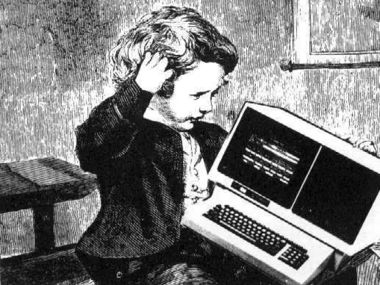 Child holding an old computer