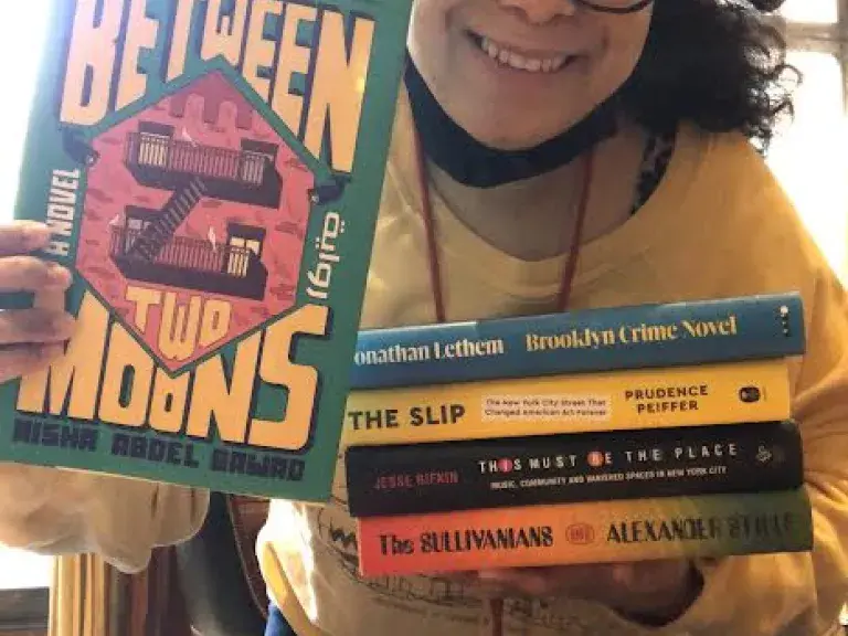 A staff member shows books
